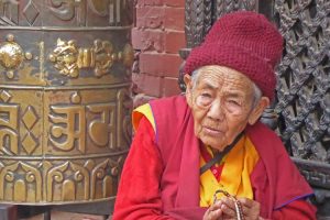 Nepalese lady with prayer beads at Boudhanath Stupa in Kathmandu