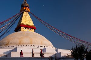 Sightseeing in Kathamandu, monks walking by the Boudhanath Stupa